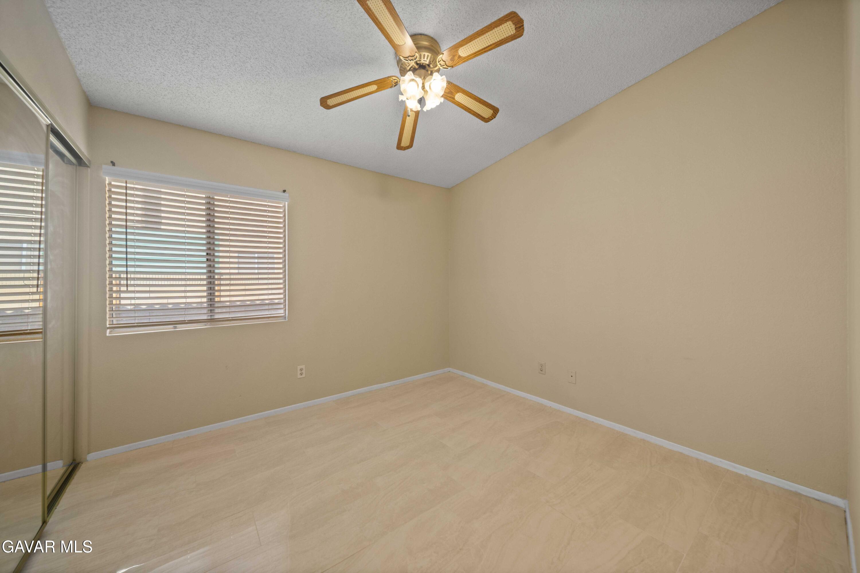 43815 Silver Bow Road Lancaster, CA 93535 - Photo 12 of 20 an empty room with a window and a fan
