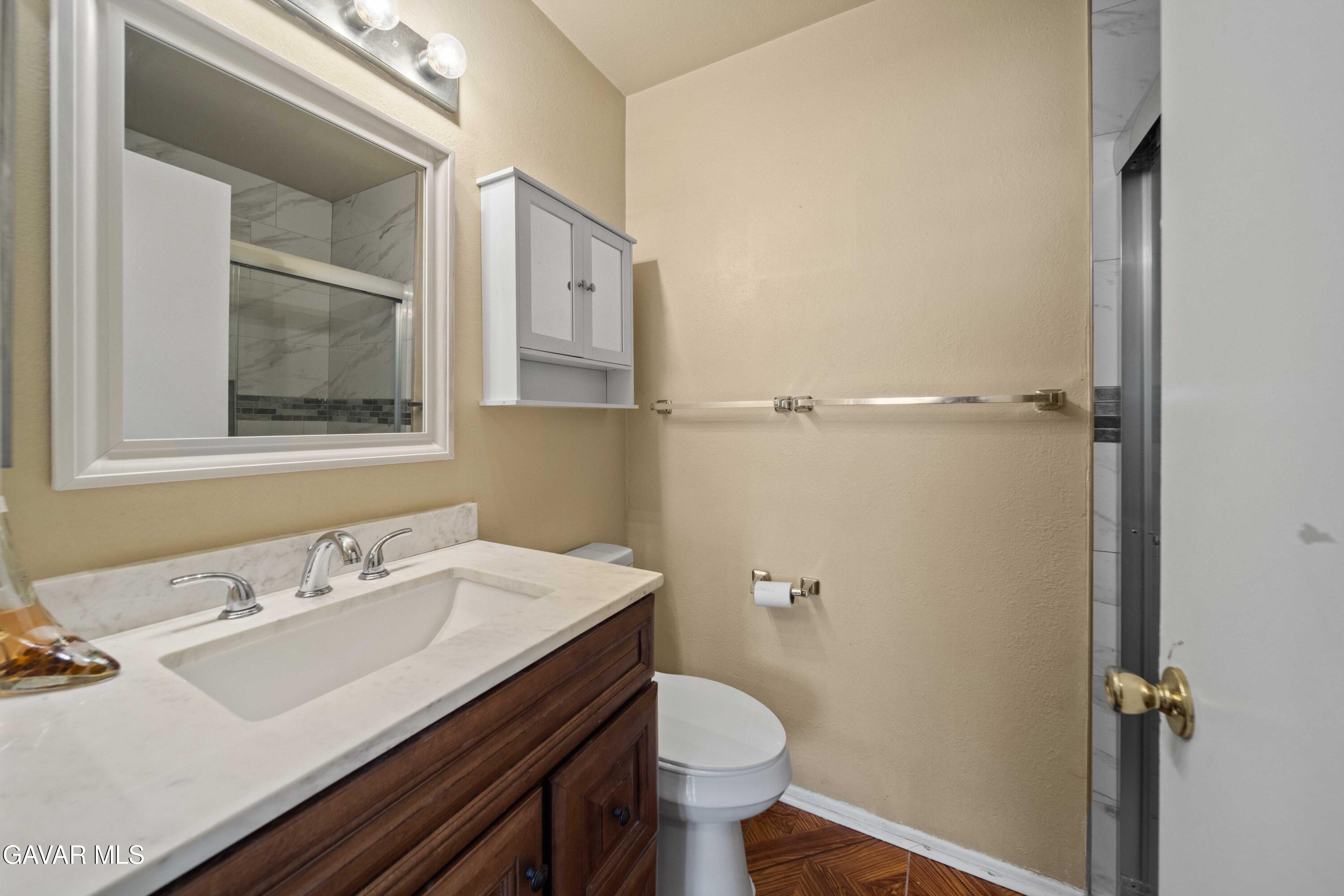 43815 Silver Bow Road Lancaster, CA 93535 - Photo 13 of 20 a bathroom with a sink and a toilet