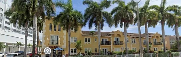 a view of multiple houses with a palm tree