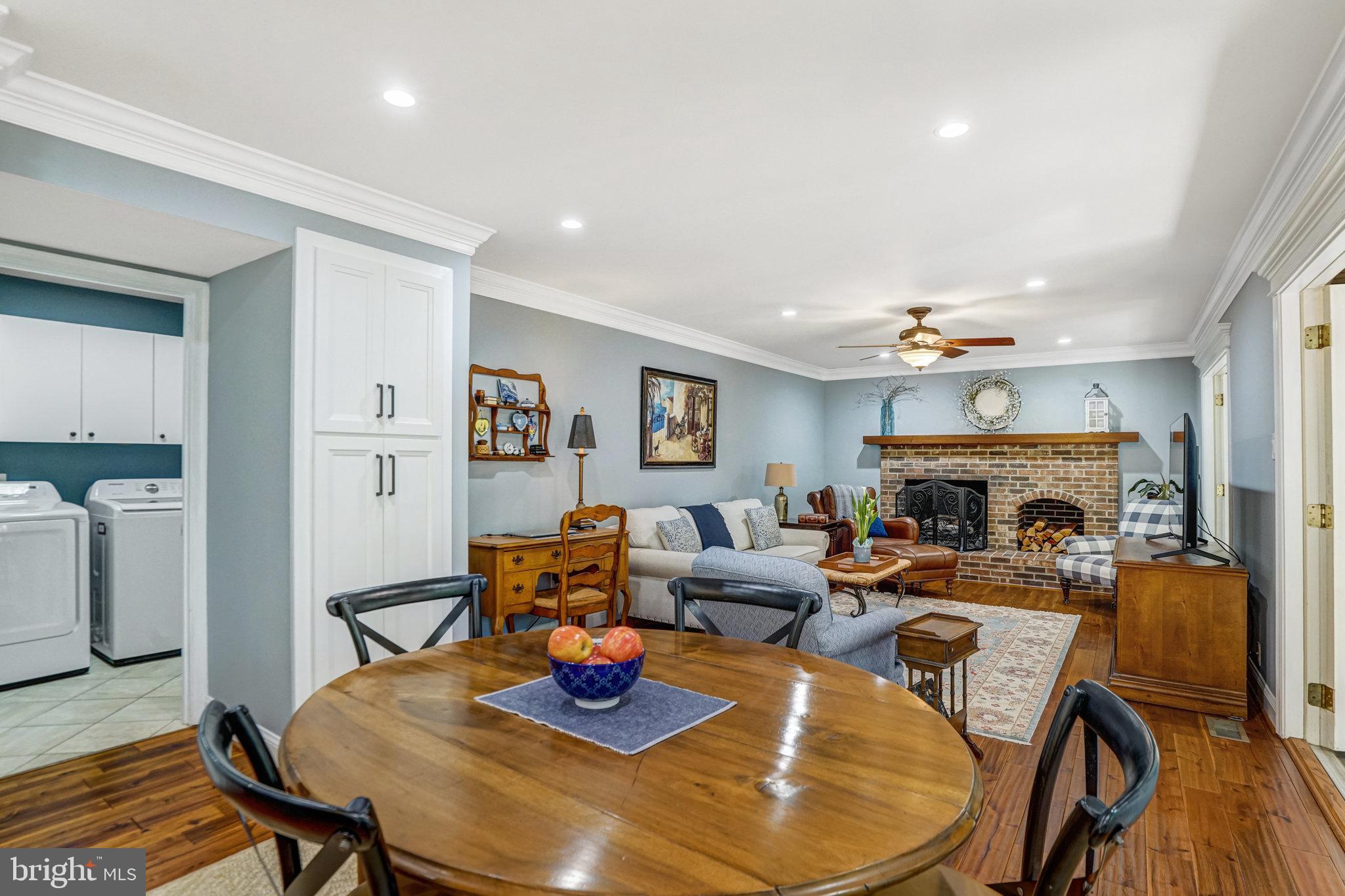 6815 Bluecurl Circle Springfield, VA 22152 - Photo 14 of 49 a living room with furniture kitchen view and a fireplace