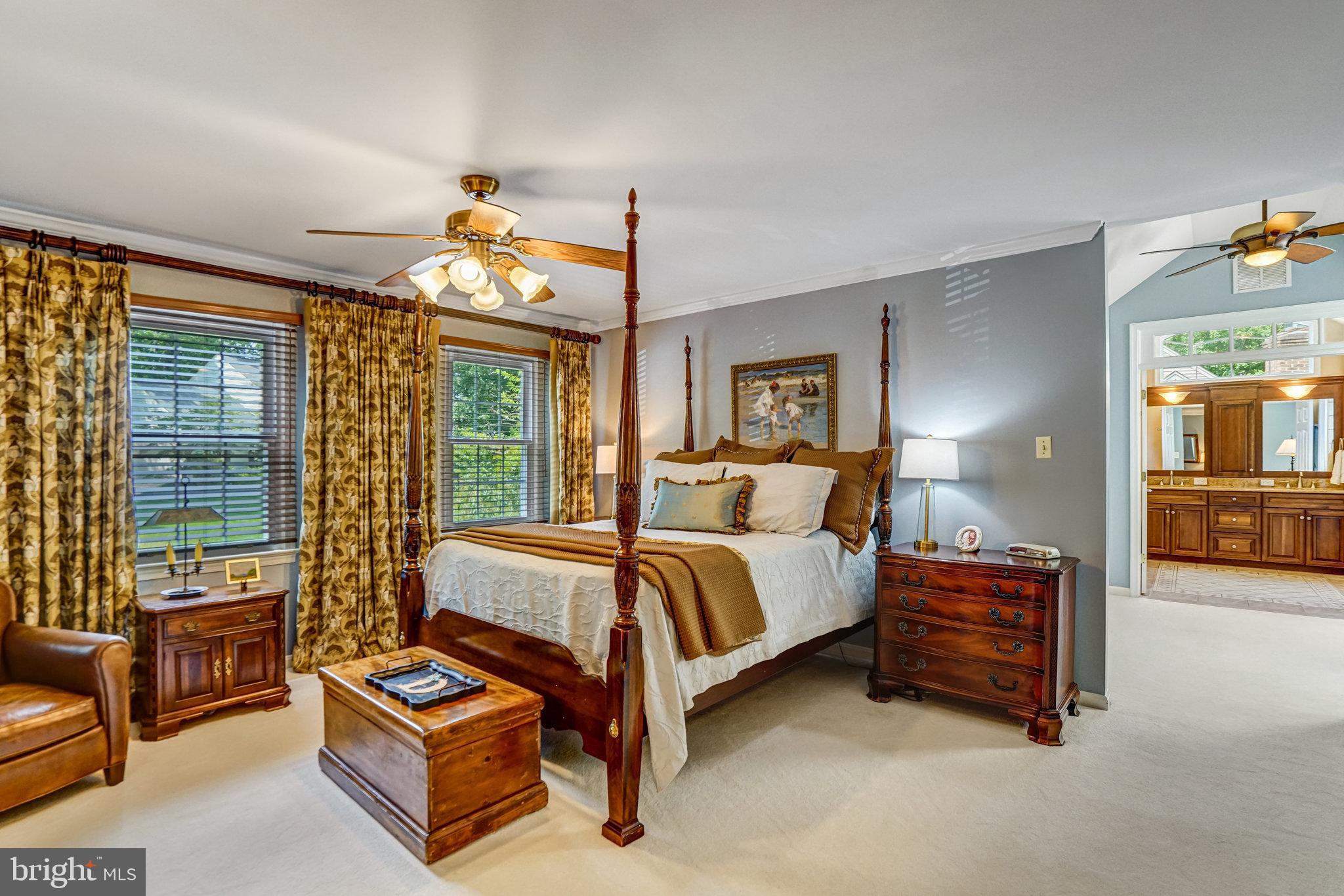 6815 Bluecurl Circle Springfield, VA 22152 - Photo 19 of 49 a spacious bedroom with a bed and a couch