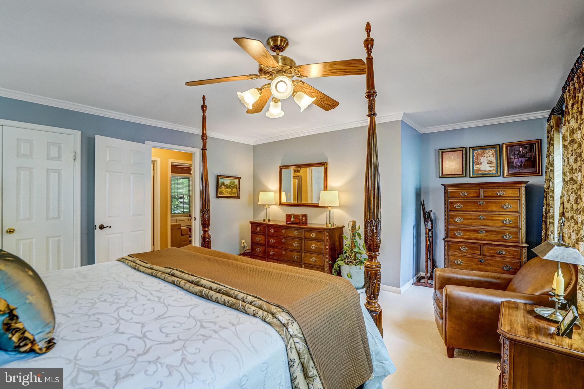 6815 Bluecurl Circle Springfield, VA 22152 - Photo 20 of 49 a bedroom with a bed and a chandelier