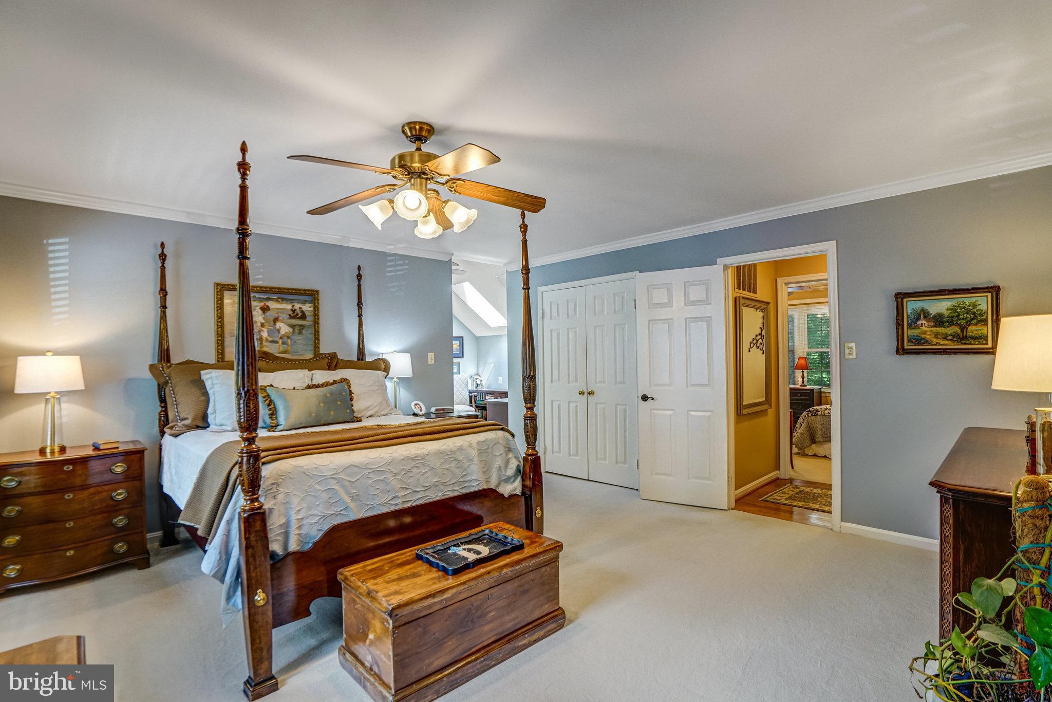 6815 Bluecurl Circle Springfield, VA 22152 - Photo 22 of 49 a bedroom with a bed and a chandelier