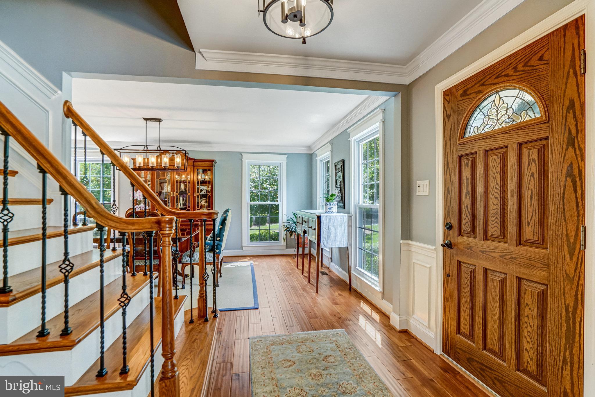 6815 Bluecurl Circle Springfield, VA 22152 - Photo 3 of 49 a view of an entryway with wooden floor and windows
