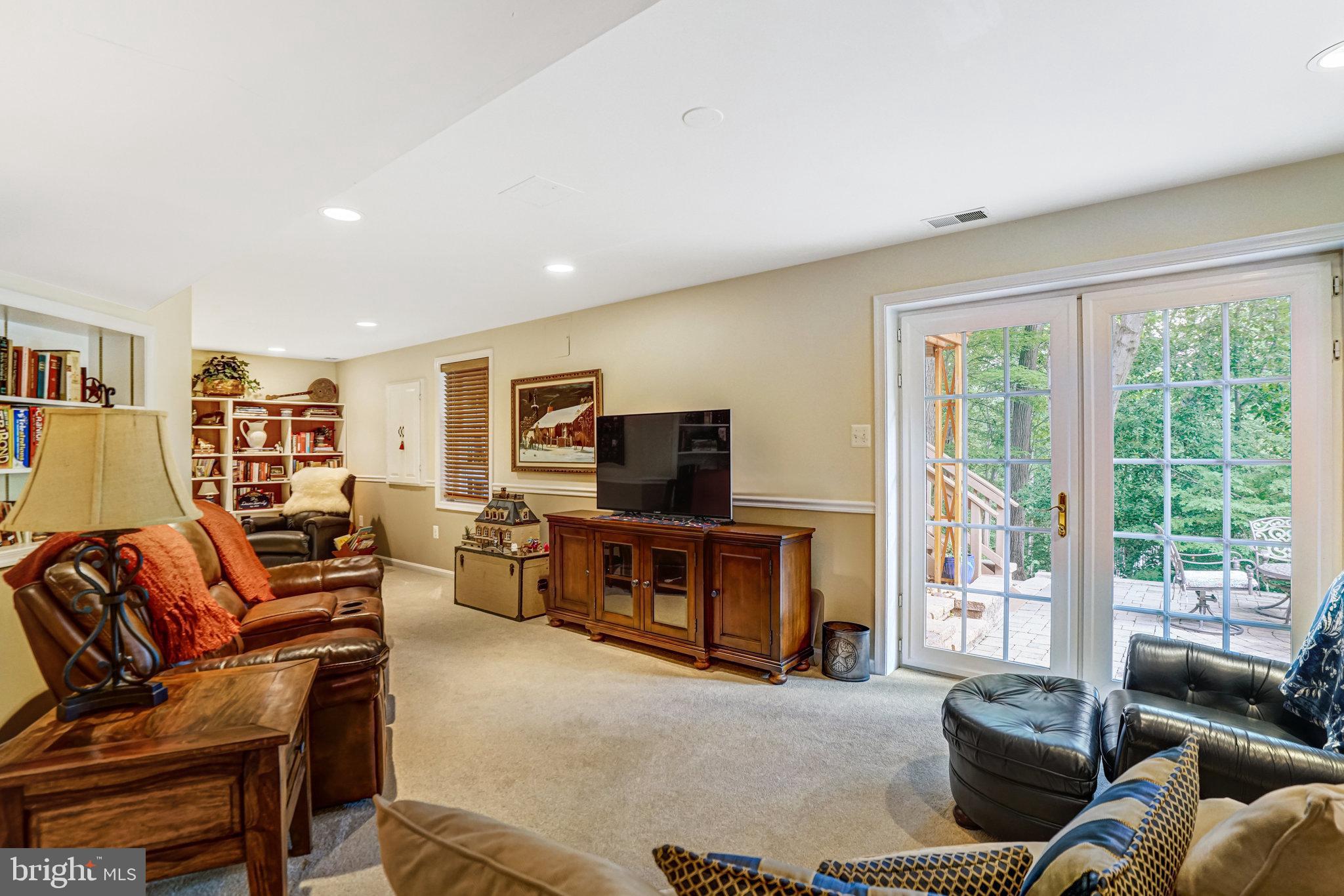 6815 Bluecurl Circle Springfield, VA 22152 - Photo 32 of 49 a living room with furniture and a flat screen tv