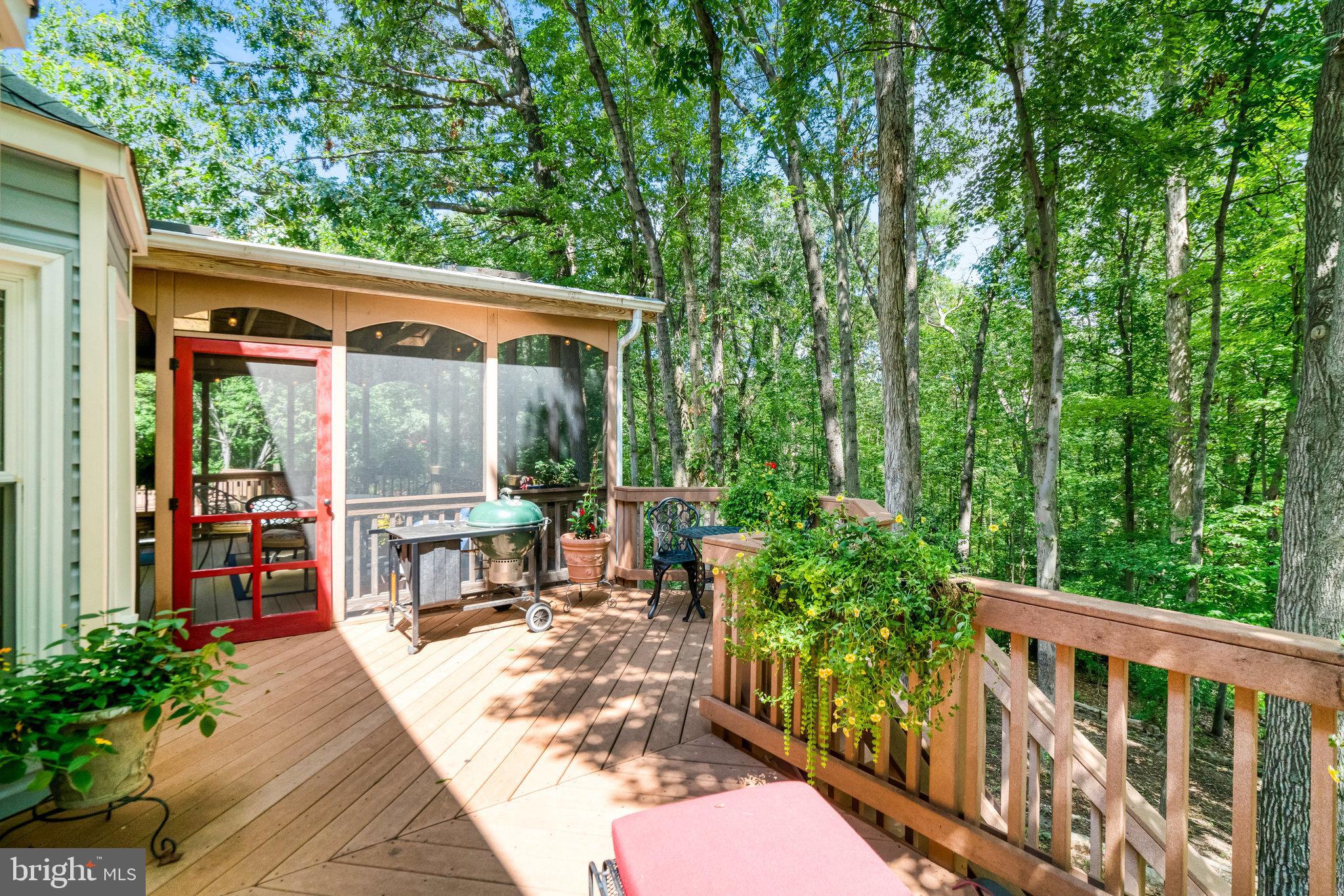 6815 Bluecurl Circle Springfield, VA 22152 - Photo 37 of 49 a view of a patio with table and chairs potted plants with wooden floor and fence