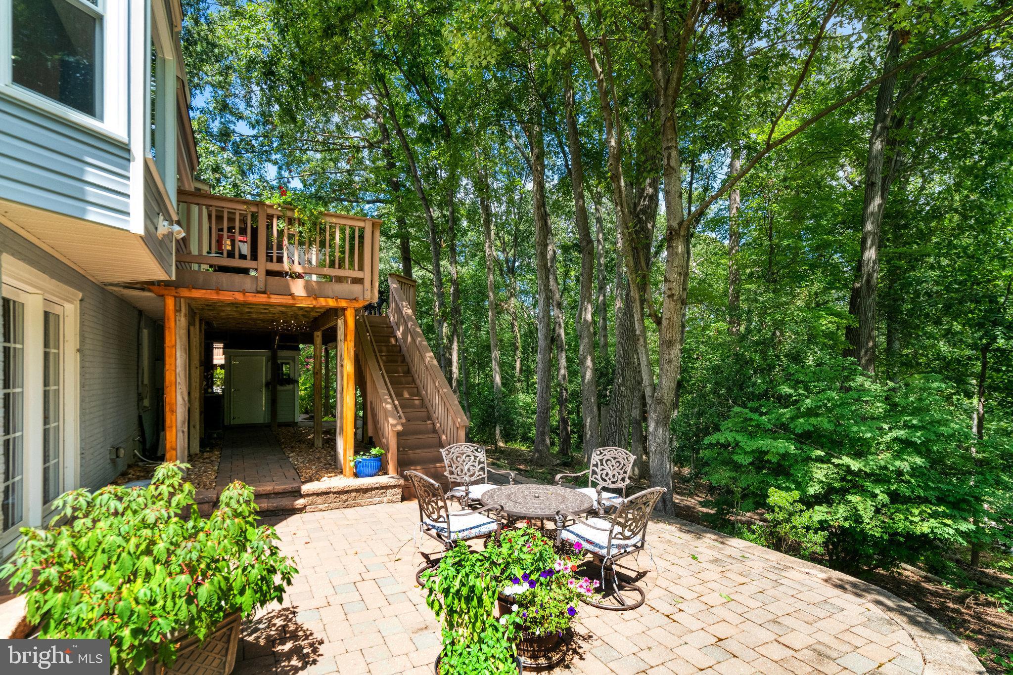 6815 Bluecurl Circle Springfield, VA 22152 - Photo 43 of 49 a view of a chair and tables in the backyard of the house