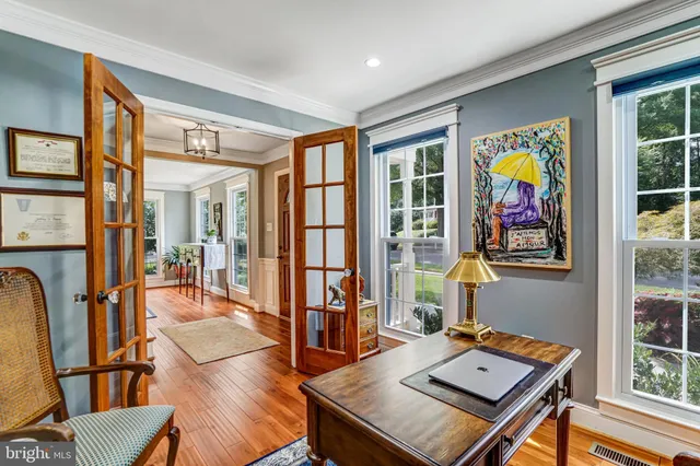 a living room with furniture and floor to ceiling windows