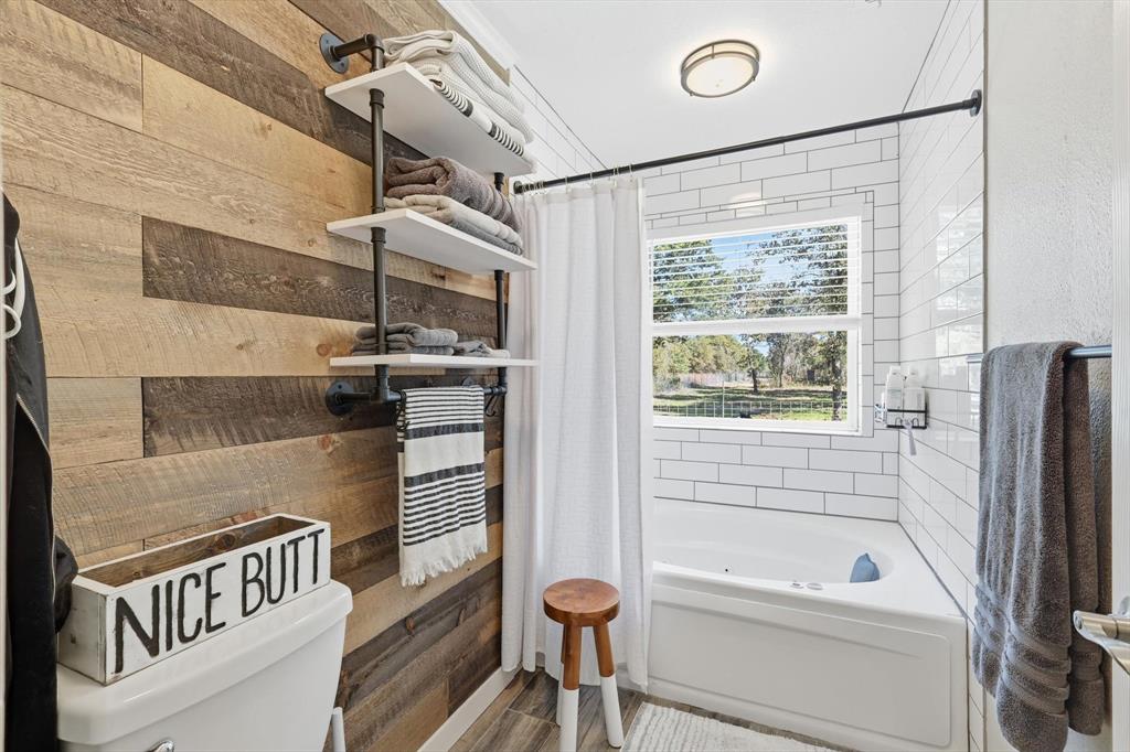 138 Gobbler Road Nocona, TX 76255 - Photo 18 of 36 a bathroom with a bathtub and a shower