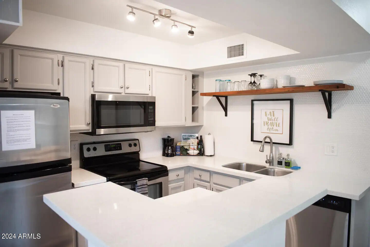602 North May, Unit 7 Mesa, AZ 85201 - Photo 6 of 18 a kitchen with a sink a microwave and cabinets