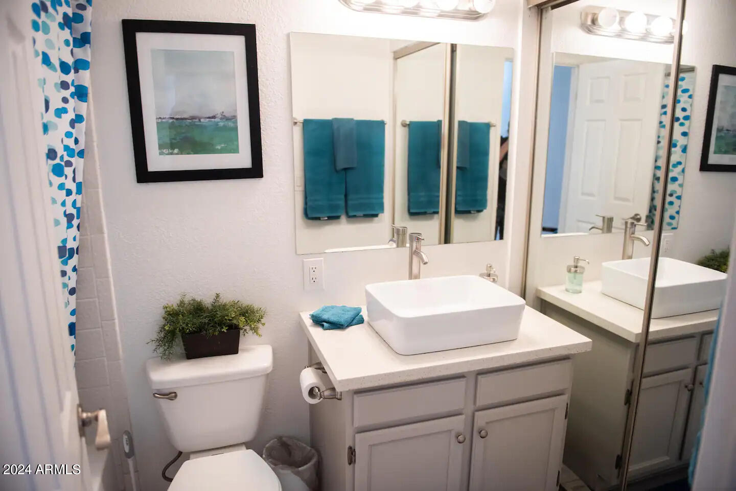 602 North May, Unit 7 Mesa, AZ 85201 - Photo 9 of 18 a bathroom with a toilet sink and mirror