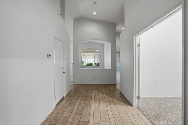 a view of a room with wooden floor a fireplace and windows