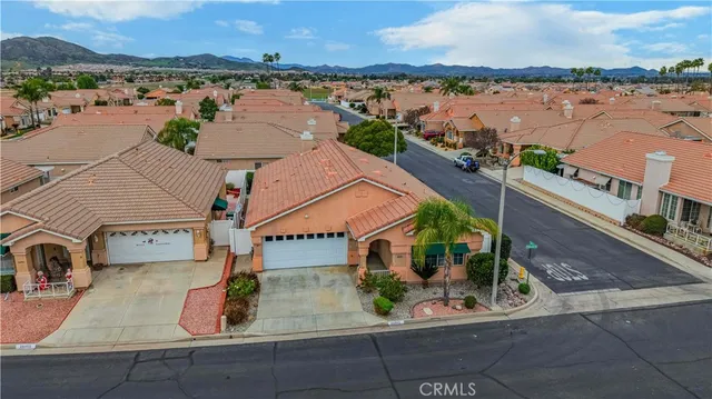 an aerial view of residential houses with outdoor space and ocean view
