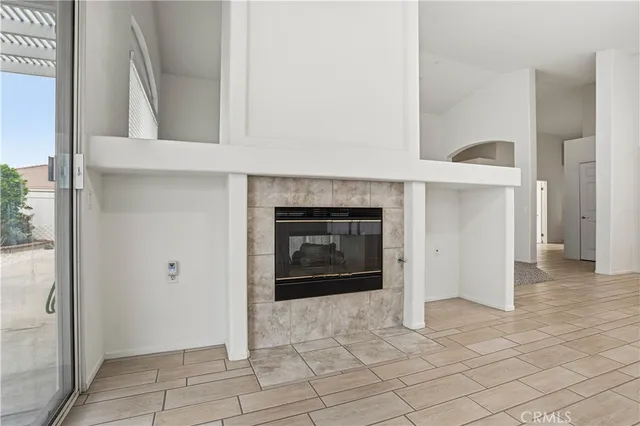 a view of a porch with a table and chairs under an umbrella