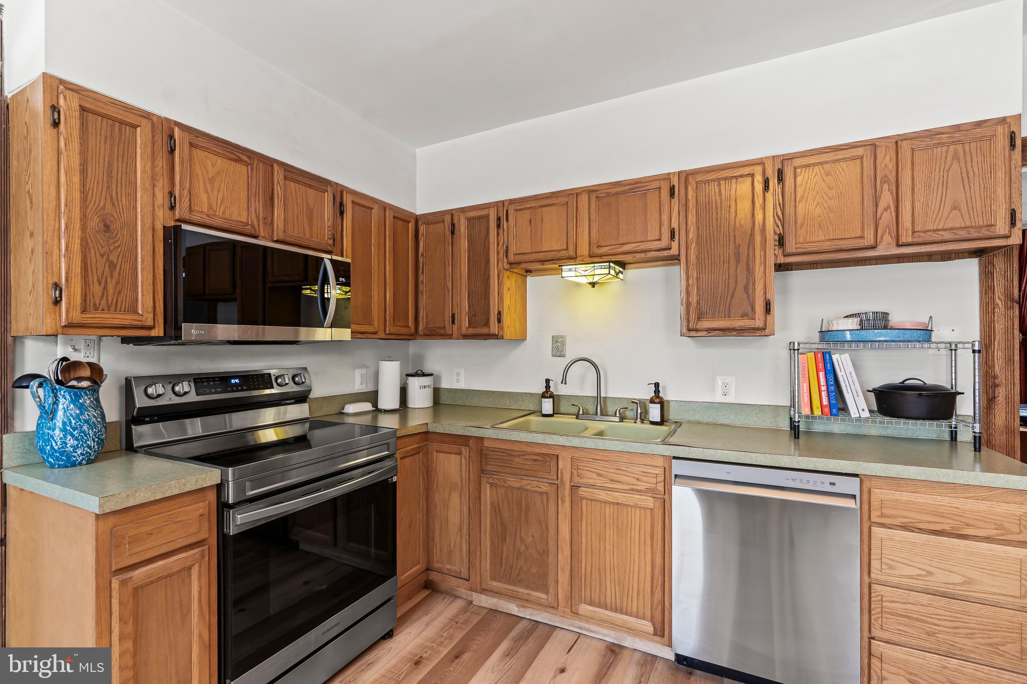 4312 Main Street Rohrersville, MD 21779 - Photo 13 of 58 a kitchen with stainless steel appliances granite countertop a sink stove and microwave