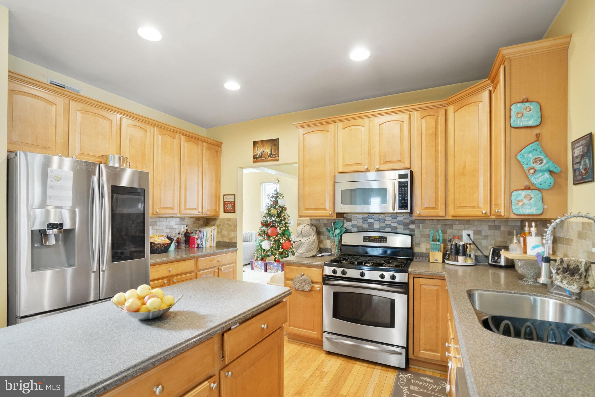 5026 Fallen Timber Way Indian Head, MD 20640 - Photo 11 of 62 a kitchen with stainless steel appliances a stove sink and cabinets