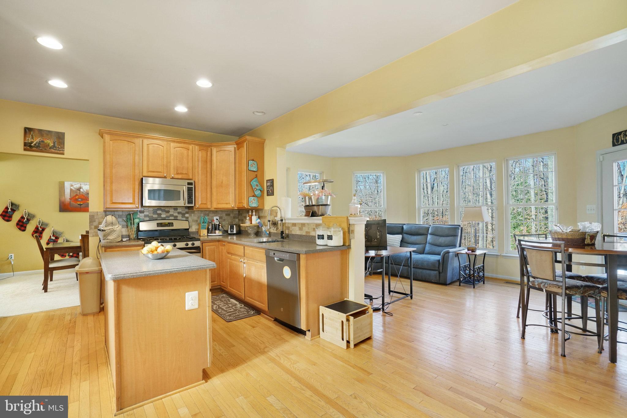 5026 Fallen Timber Way Indian Head, MD 20640 - Photo 13 of 62 a kitchen with sink refrigerator dining table and chairs
