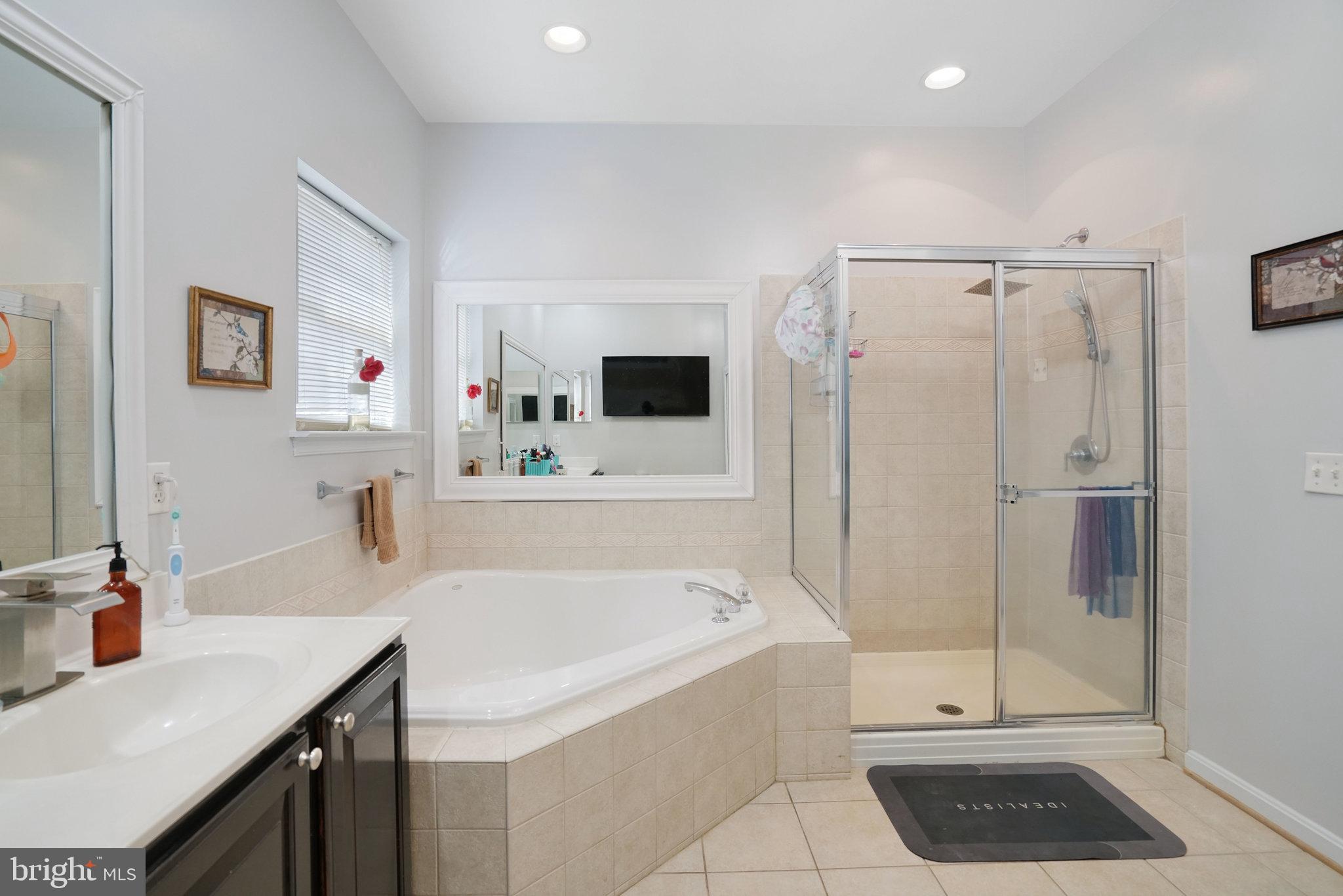 5026 Fallen Timber Way Indian Head, MD 20640 - Photo 28 of 62 a bathroom with a tub a sink and a mirror