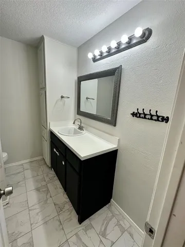 a bathroom with a sink vanity and a mirror