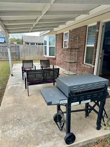 a living room with a table chairs and a wooden floor