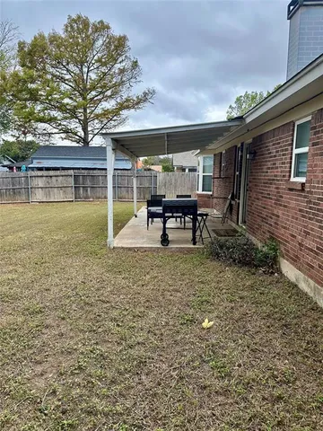 a view of a house with backyard porch and sitting area