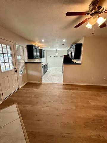 a view of a living room a flat screen tv and a large window