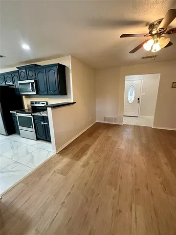 a view of a kitchen with wooden floor