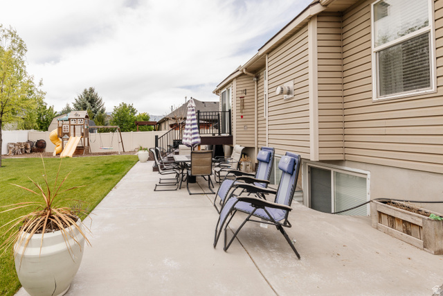 972 West 2840th Street South Logan, UT 84321 - Photo 44 of 46 Expansive concrete patio with direct access to a grassy yard, featuring a white privacy fence