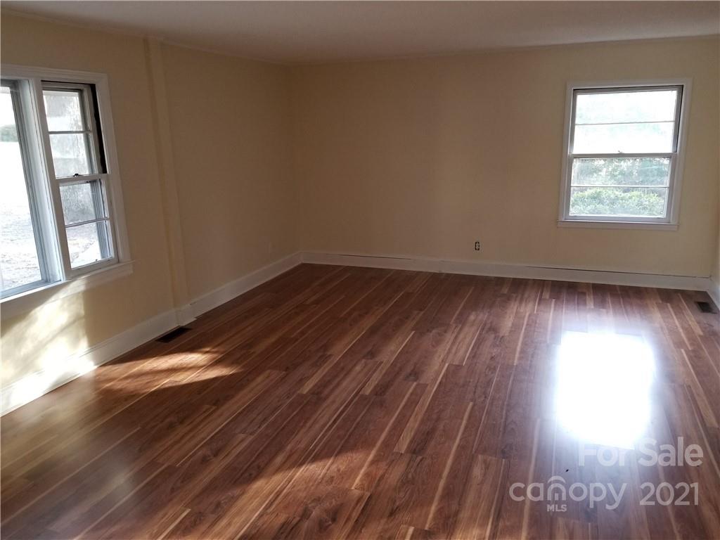 902 Druid Circle Charlotte, NC 28206 - Photo 14 of 24 wooden floor in an empty room with a window