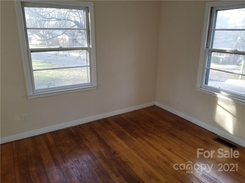 902 Druid Circle Charlotte, NC 28206 - Photo 3 of 24 a view of an empty room with wooden floor and a window