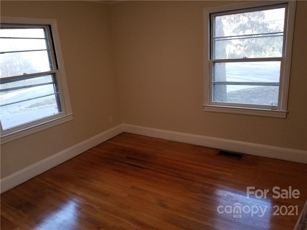 902 Druid Circle Charlotte, NC 28206 - Photo 6 of 24 a view of empty room with wooden floor and fan