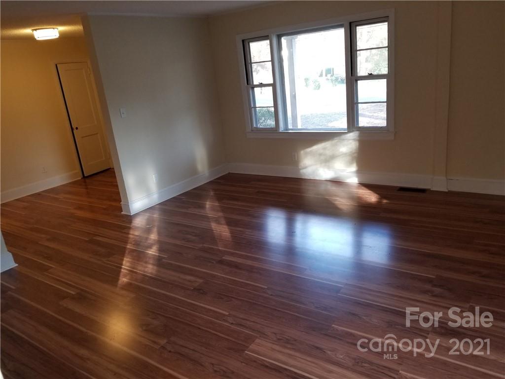 902 Druid Circle Charlotte, NC 28206 - Photo 9 of 24 an empty room with wooden floor and windows