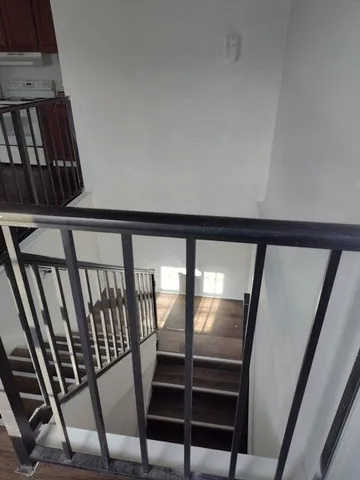 a view of staircase with lots of wooden floor and windows