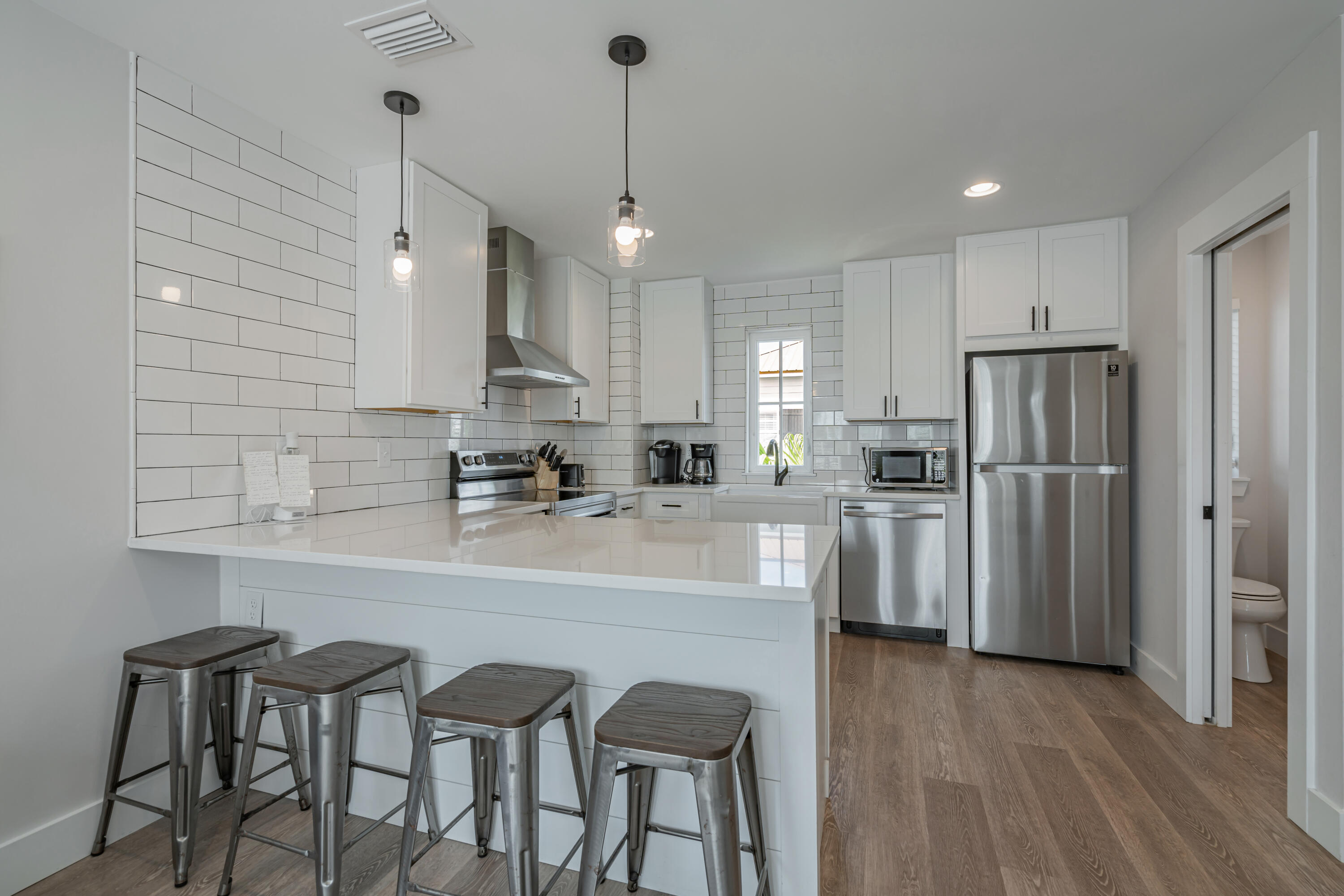 41 Abbie Road Santa Rosa Beach, FL 32459 - Photo 10 of 38 a kitchen with refrigerator a sink and chairs