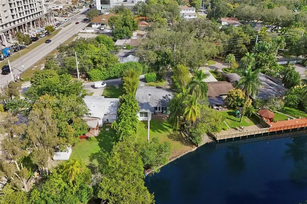 an aerial view of a residential houses with yard