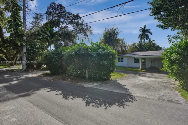 a view of a house with a backyard