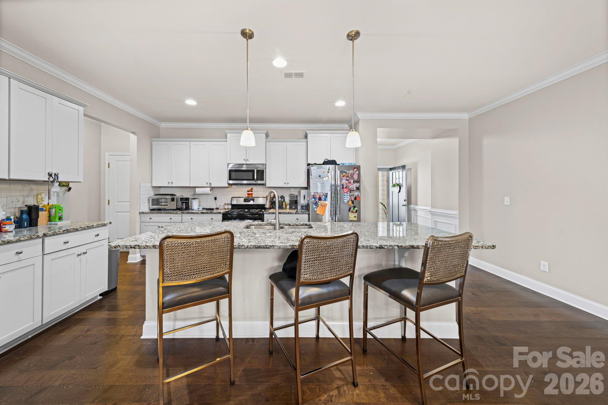 1425 Bramblewood Drive Fort Mill, SC 29708 - Photo 13 of 44 a kitchen with kitchen island a dining table chairs and white cabinets