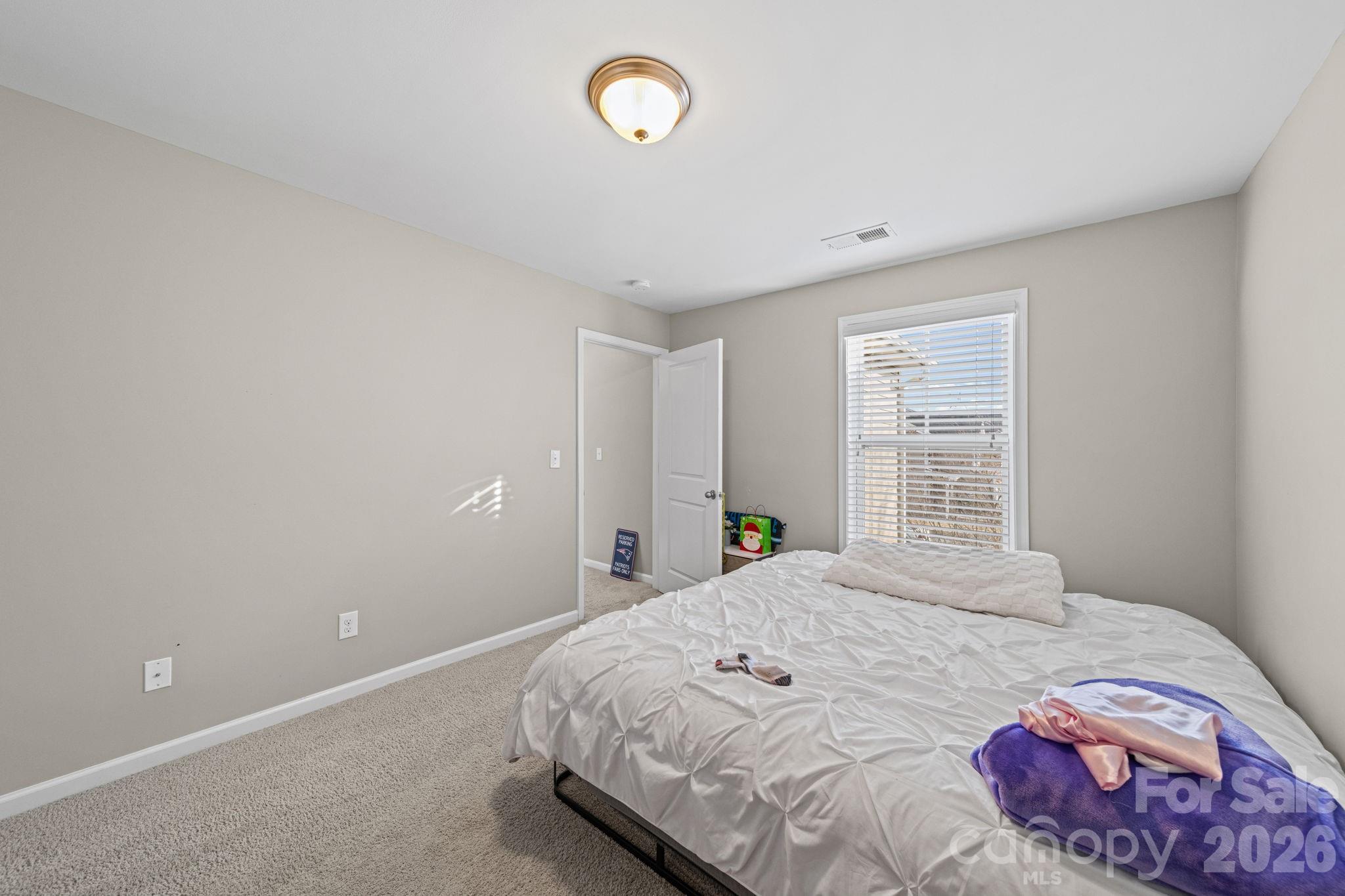 1425 Bramblewood Drive Fort Mill, SC 29708 - Photo 23 of 44 a bedroom with a bed and a window
