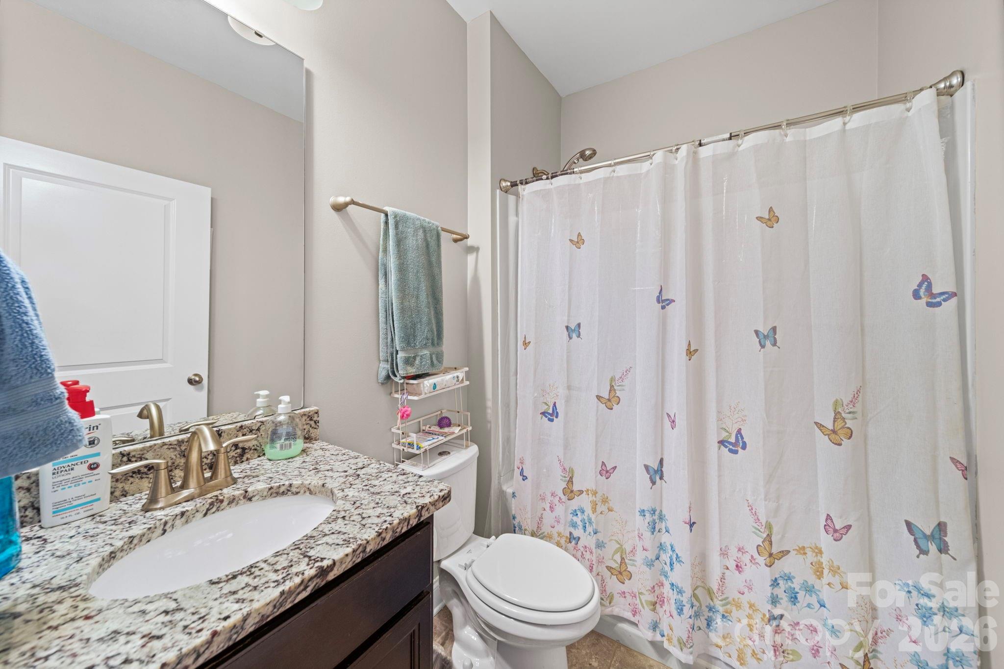 1425 Bramblewood Drive Fort Mill, SC 29708 - Photo 24 of 44 a bathroom with a granite countertop sink toilet and shower
