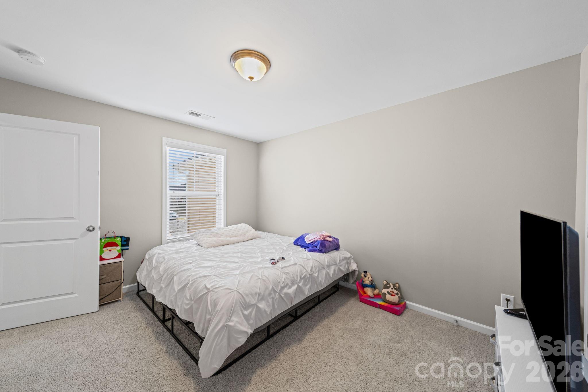 1425 Bramblewood Drive Fort Mill, SC 29708 - Photo 25 of 44 a bedroom with a bed and a flat screen tv