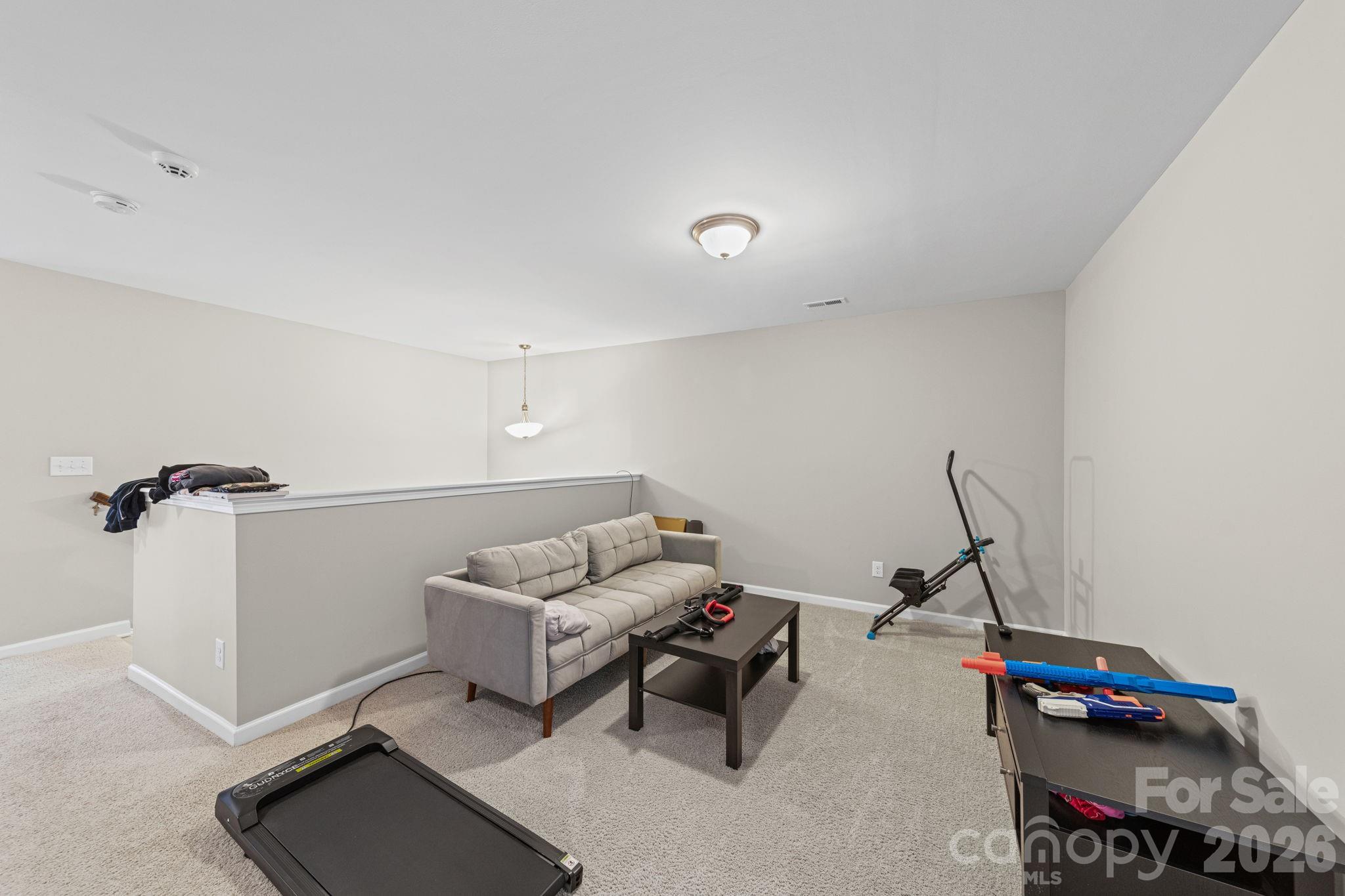 1425 Bramblewood Drive Fort Mill, SC 29708 - Photo 27 of 44 a living room with furniture and a gym machine