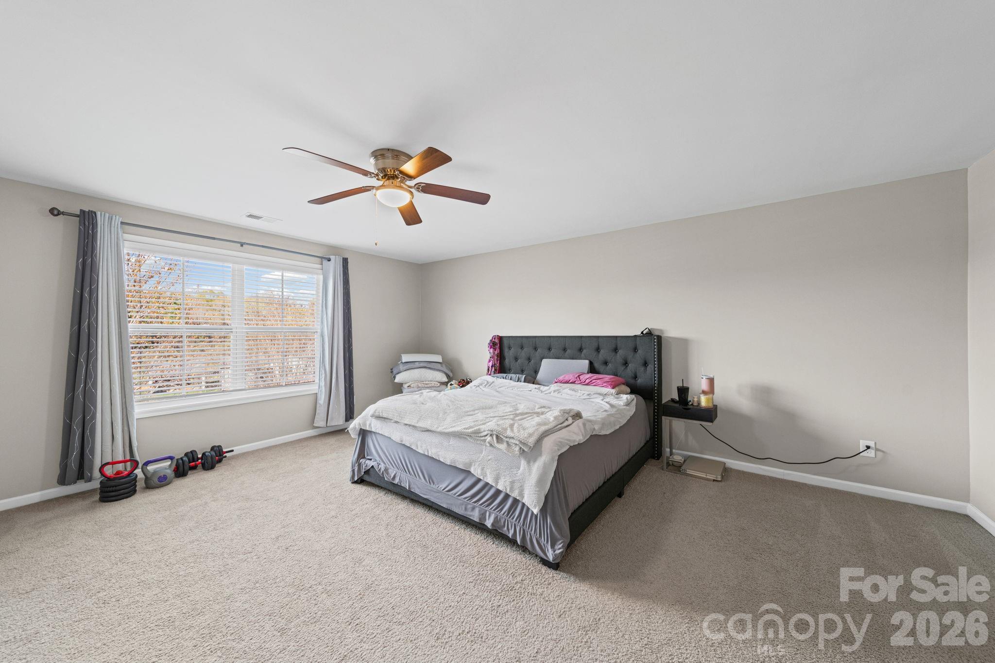 1425 Bramblewood Drive Fort Mill, SC 29708 - Photo 28 of 44 a spacious bedroom with a bed and a large window