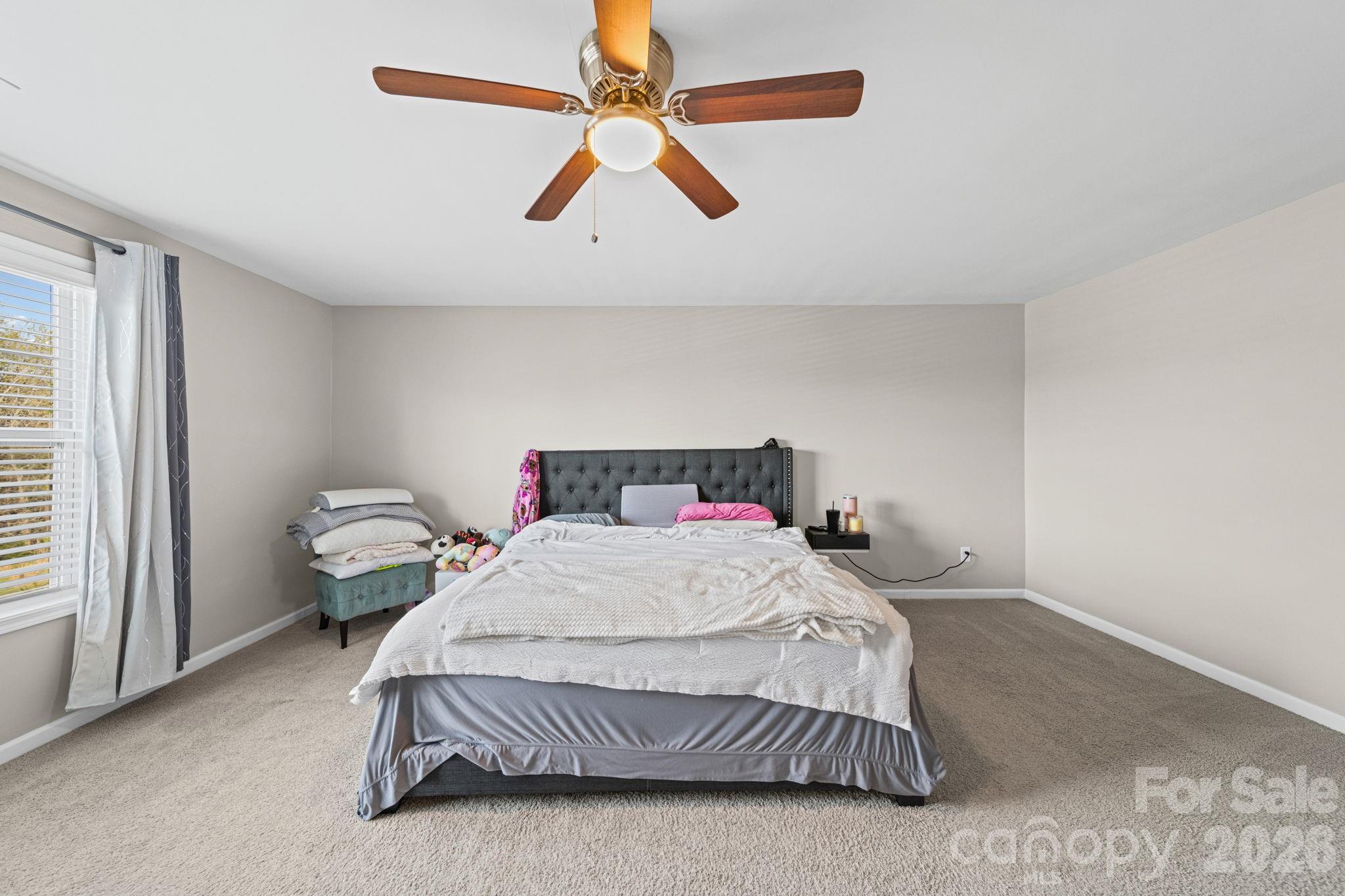 1425 Bramblewood Drive Fort Mill, SC 29708 - Photo 30 of 44 a bedroom with a bed ceiling fan and a window