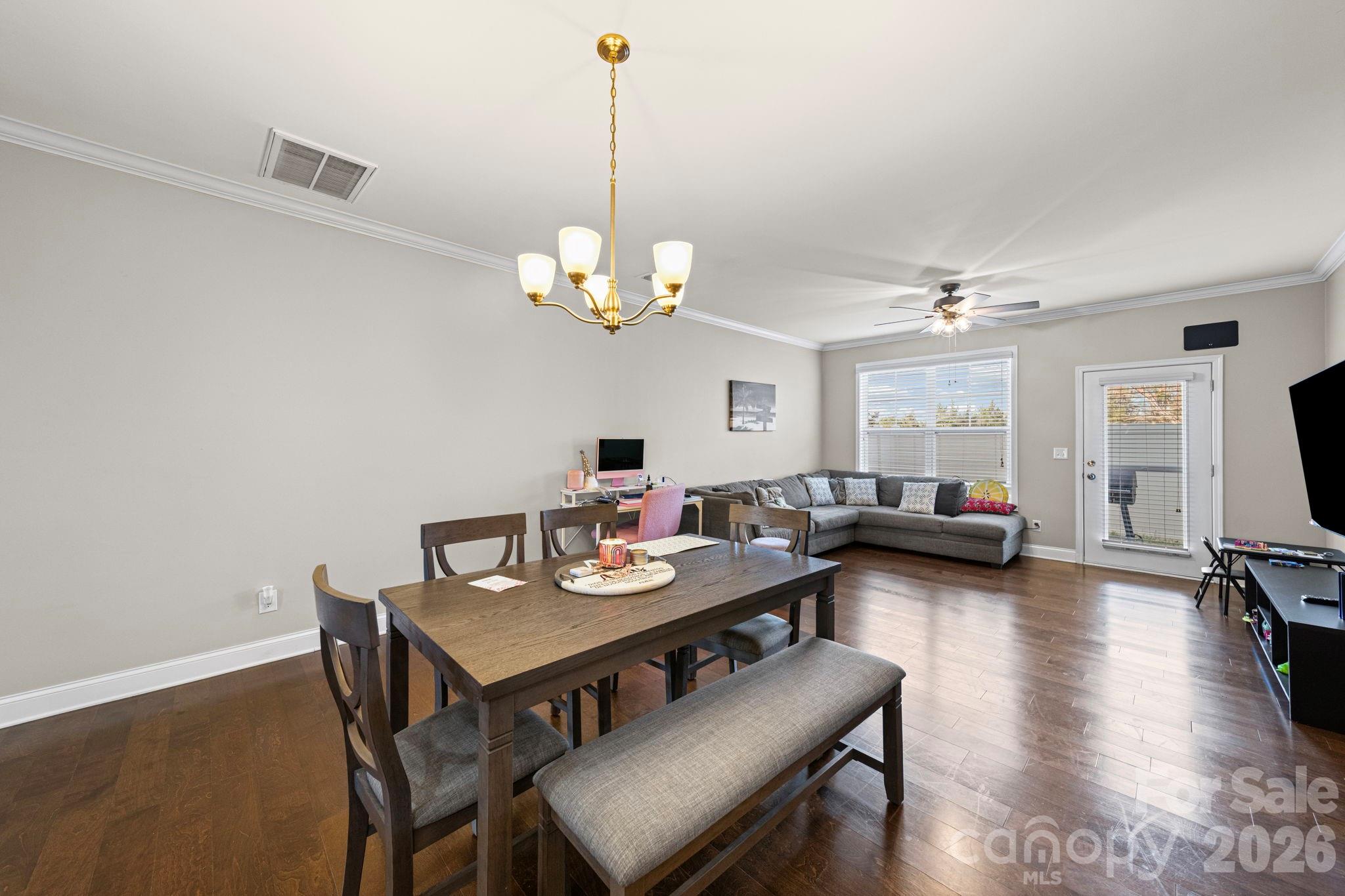 1425 Bramblewood Drive Fort Mill, SC 29708 - Photo 7 of 44 a view of a dining room with furniture a chandelier and wooden floor