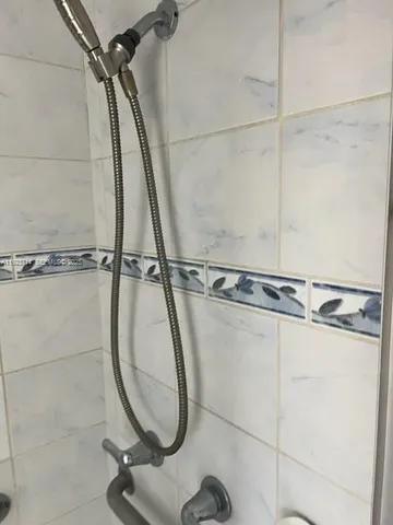 a bathroom with a shower and a sink