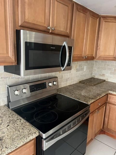 8001 Crespi Boulevard, Unit 2D Miami Beach, FL 33141 - Photo 6 of 20 a stove top oven sitting inside of a kitchen
