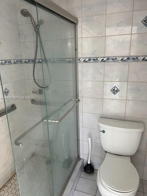 8001 Crespi Boulevard, Unit 2D Miami Beach, FL 33141 - Photo 9 of 20 a bathroom with a toilet and shower