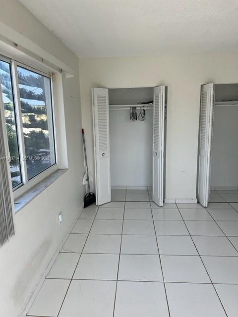 8001 Crespi Boulevard, Unit 2D Miami Beach, FL 33141 - Photo 10 of 20 a view of a livingroom with an empty space and a window