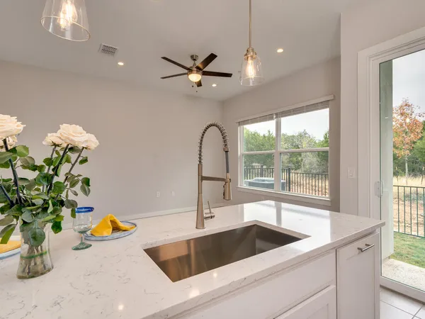 a kitchen with a sink a counter space and a window