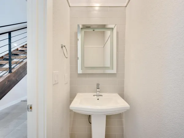 a bathroom with a sink a mirror and vanity